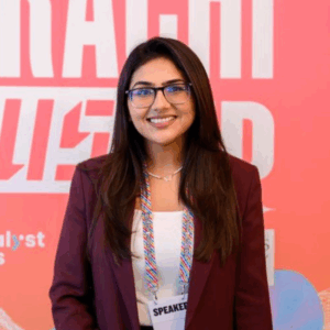Azima Dhanjee, co-founder of ConnectHear, smiling while using sign language symbolizing communication, inclusion, and empowerment.