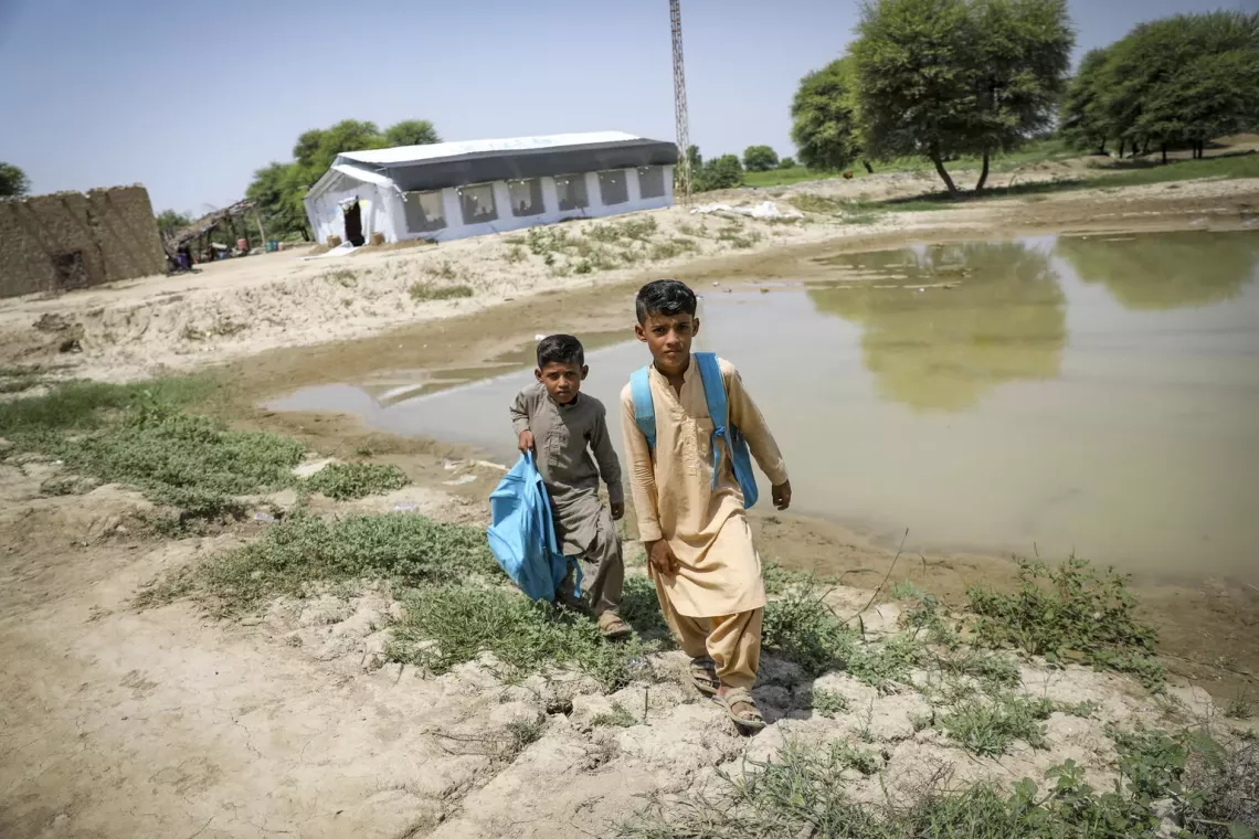 Children affected by floods in Pakistan seeking shelter and safety.