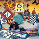 Colorful kites and string spools displayed in a busy Lahore market during Basant, highlighting Pakistan’s seasonal kite economy and small businesses